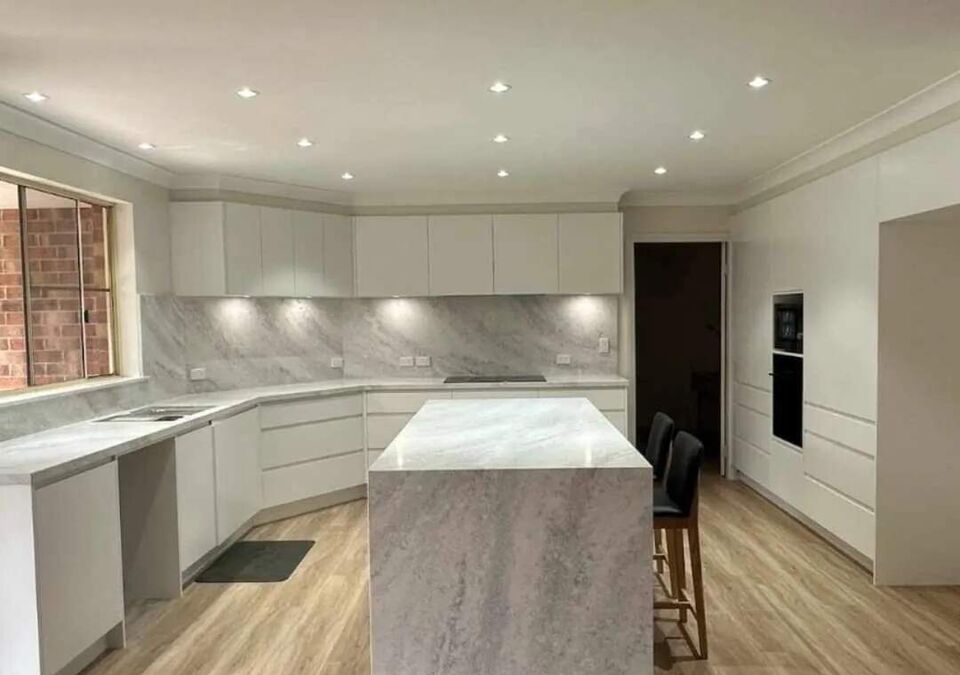 A bright kitchen with a white stone island