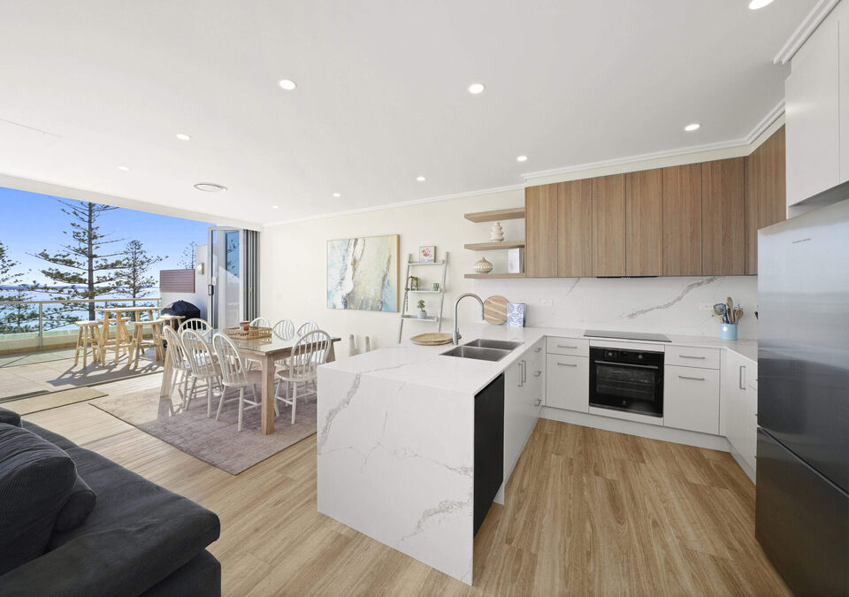 A bright open-plan kitchen with a white stone island