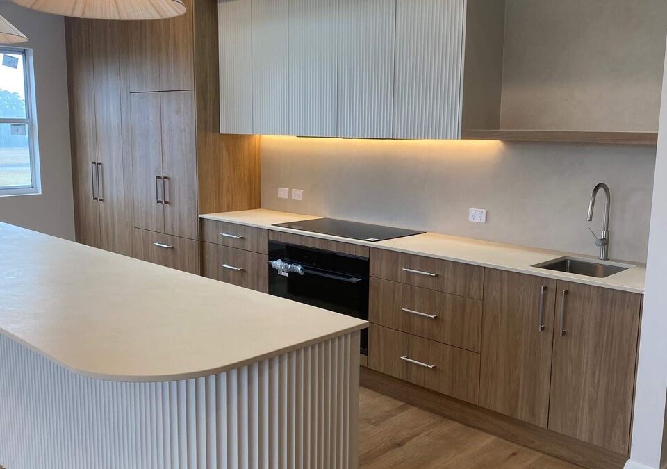 A modern kitchen with a curved stone island